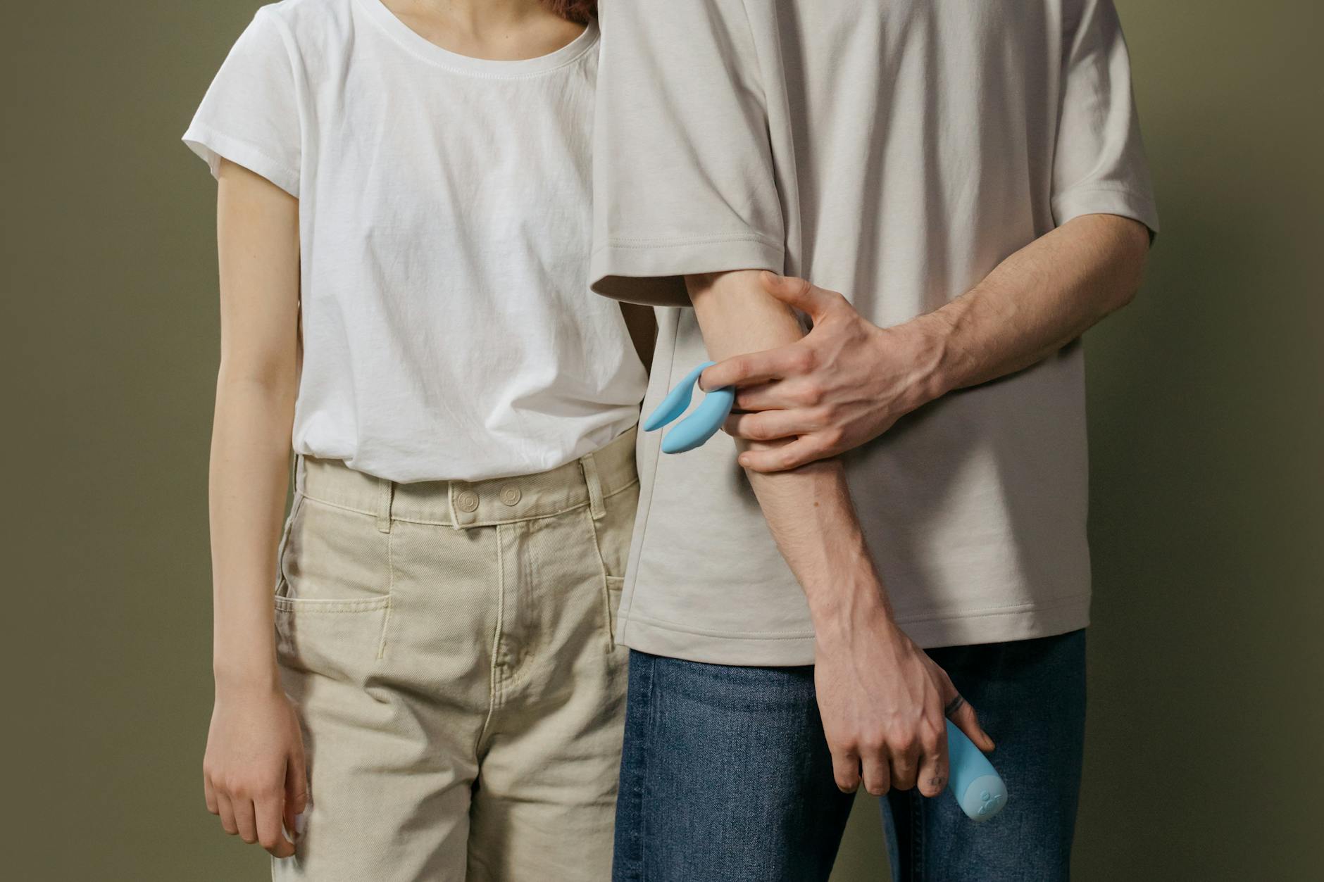 A couple holding hands indoors, representing emotional connection during recovery and healing